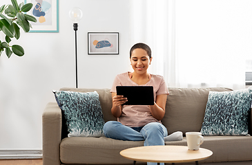 Image showing african american woman with tablet pc at home