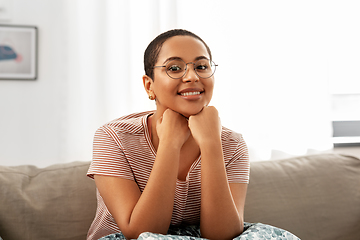 Image showing african american woman in glasses sitting on sofa