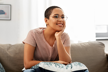 Image showing african american woman in glasses sitting on sofa