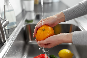 Image showing woman washing fruits and vegetables in kitchen