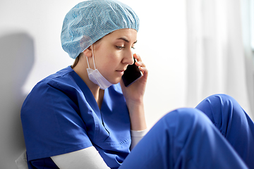 Image showing sad doctor or nurse calling on smartphone