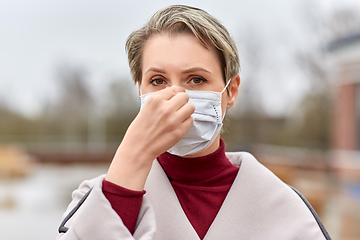 Image showing young woman wearing protective medical mask