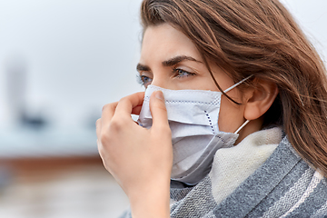 Image showing young woman wearing protective medical mask