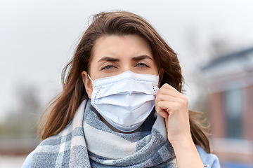 Image showing young woman wearing protective medical mask