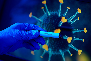 Image showing hand holding beaker with coronavirus blood test