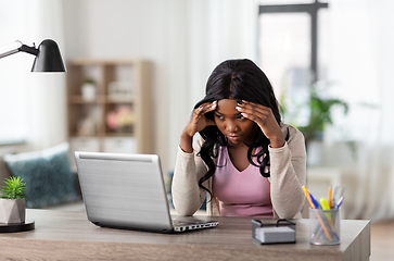 Image showing stressed woman with laptop working at home office