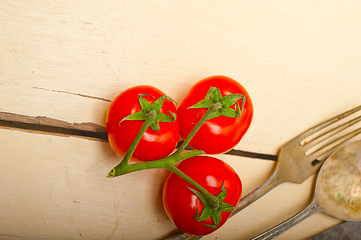 Image showing ripe cherry tomatoes over white wood