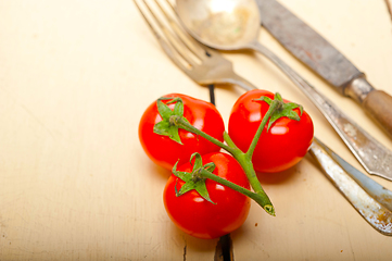 Image showing ripe cherry tomatoes over white wood