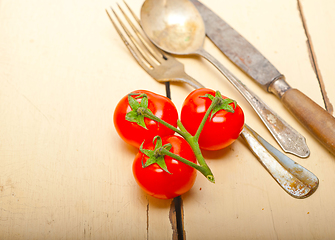 Image showing ripe cherry tomatoes over white wood