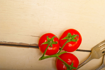 Image showing ripe cherry tomatoes over white wood