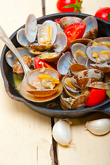 Image showing fresh clams on an iron skillet