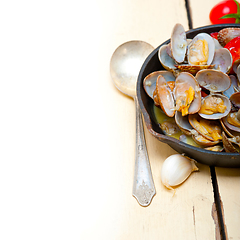 Image showing fresh clams on an iron skillet