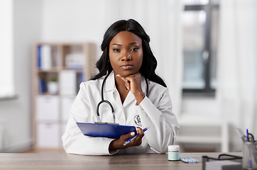 Image showing african american doctor with clipboard at hospital