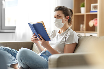 Image showing sick woman in medical mask reading book at home