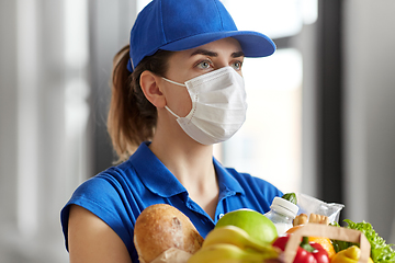 Image showing delivery woman in face mask with food in paper bag