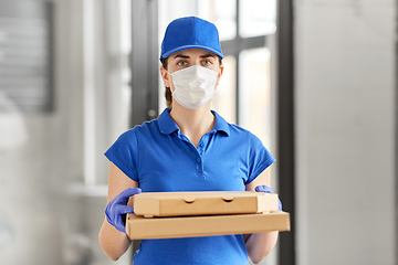 Image showing delivery woman in face mask with pizza boxes