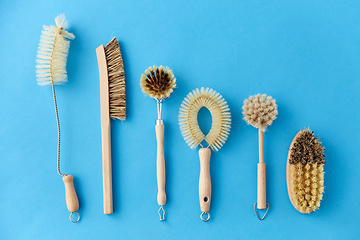 Image showing different cleaning brushes on blue background