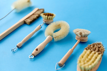 Image showing different cleaning brushes on blue background