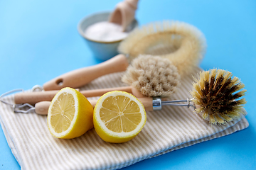 Image showing cleaning brushes, lemon and washing soda on cloth