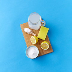 Image showing lemons, washing soda and sponge on wooden board