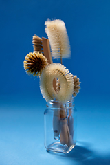 Image showing different natural cleaning brushes in glass jar