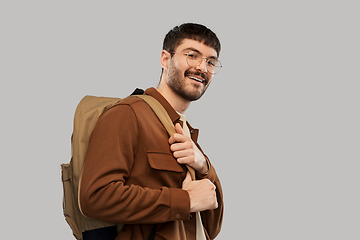 Image showing smiling young man in glasses with backpack