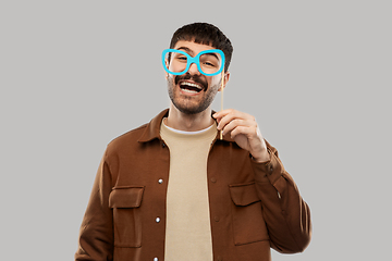 Image showing happy smiling man with glasses party accessory