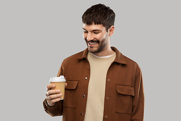 Image showing smiling young man with takeaway coffee cup
