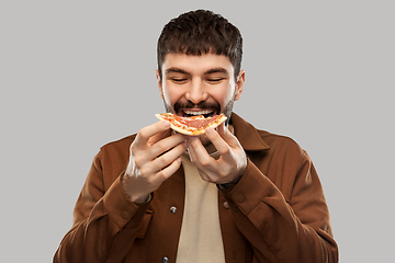 Image showing happy smiling young man eating pizza