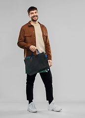 Image showing happy smiling young man with shopping bags