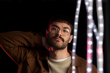 Image showing man in glasses over neon lights at nightclub