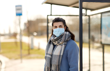 Image showing young woman wearing medical mask at bus stop