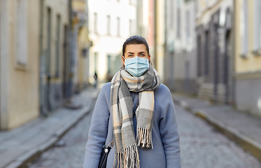 Image showing young woman wearing protective medical mask