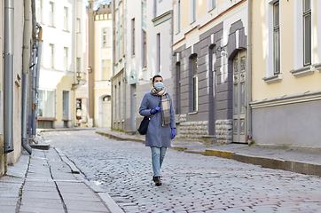 Image showing young woman wearing protective medical mask