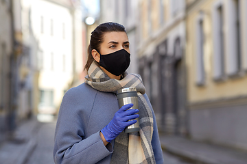 Image showing woman in reusable mask with tumbler in city