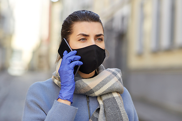 Image showing woman in protective reusable mask calling on phone