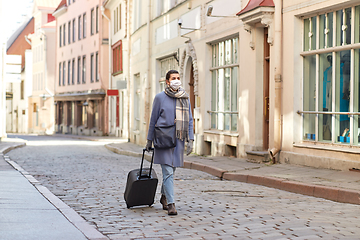Image showing woman in protective mask with travel bag in city
