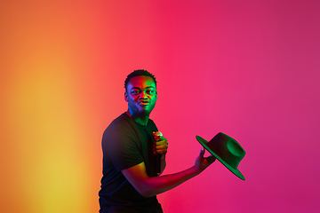 Image showing Young african-american musician singing, dancing in neon light