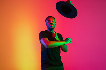 Image showing Young african-american musician singing, dancing in neon light