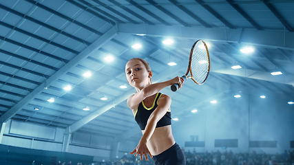 Image showing Little caucasian girl playing tennis on sport court background