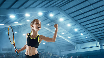 Image showing Little caucasian girl playing tennis on sport court background