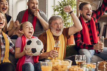 Image showing Excited, happy big family team watch football, soccer match together on the couch at home