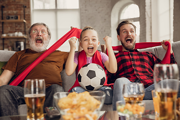 Image showing Excited, happy big family team watch football, soccer match together on the couch at home