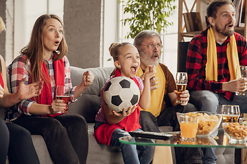 Image showing Excited, happy big family team watch football, soccer match together on the couch at home