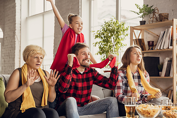 Image showing Excited, happy big family team watch football, soccer match together on the couch at home