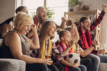 Image showing Excited, happy big family team watch football, soccer match together on the couch at home