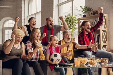 Image showing Excited, happy big family team watch football, soccer match together on the couch at home