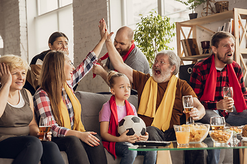 Image showing Excited, happy big family team watch football, soccer match together on the couch at home