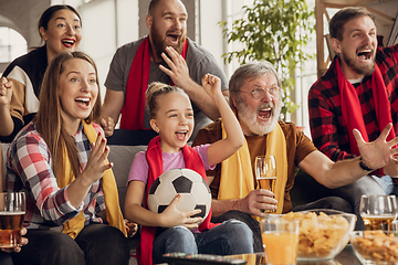 Image showing Excited, happy big family team watch football, soccer match together on the couch at home