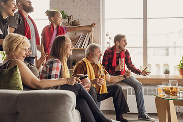 Image showing Excited, happy big family team watch football, soccer match together on the couch at home